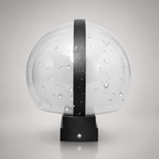 Transparent water-dotted dome with a black vertical strap and base.