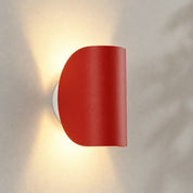 Red curved wall light with up-and-down lighting