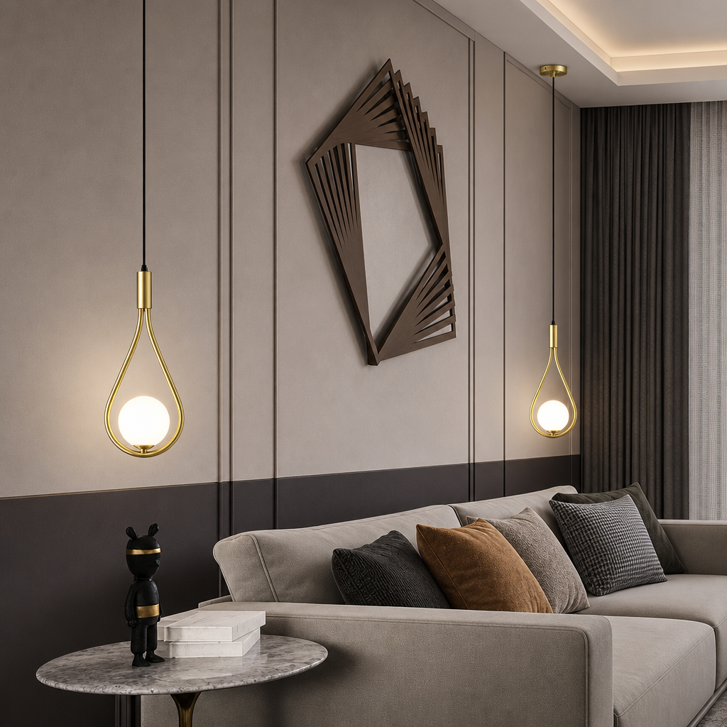 Two gold teardrop pendant lights glowing beside a gray sofa in a modern living room.