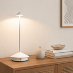 White minimalist touch table lamp on a wooden cabinet.