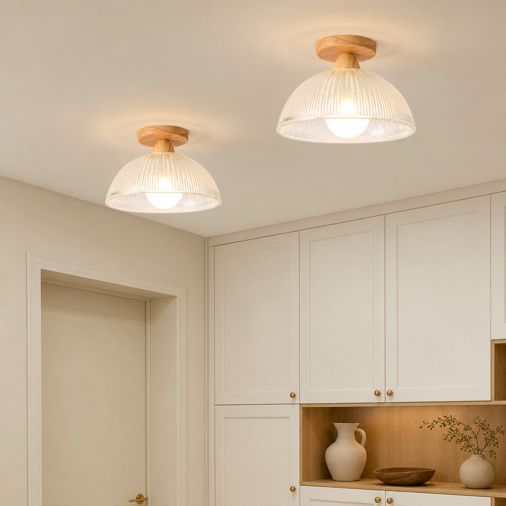 Two ribbed white dome ceiling lights with wooden mounts glow warmly in a bright room.