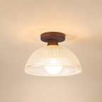 Warm ceiling light with wooden mount and ribbed translucent dome shade.