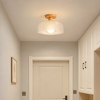 Wood and woven cream semi-flush ceiling light glowing in a cozy hallway.