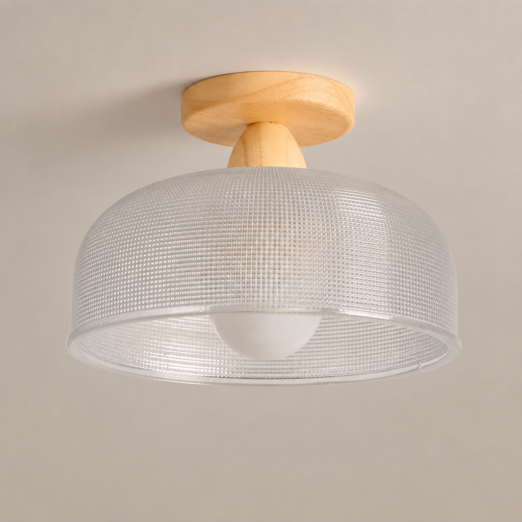 Flush mount ceiling light with wood base and translucent textured drum shade.