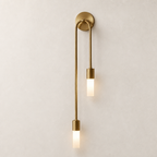 Brass double pendant wall sconce with two glowing frosted rectangular shades.
