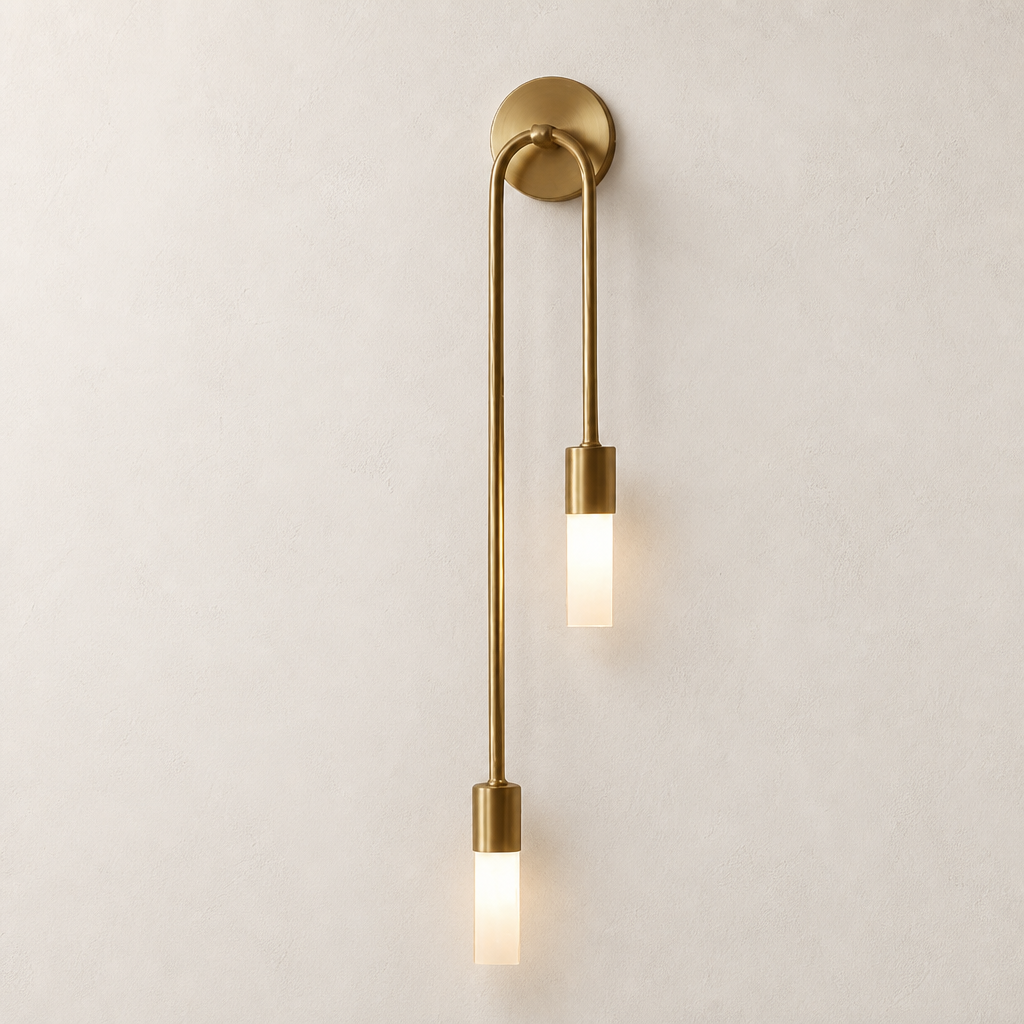 Brass double pendant wall sconce with two glowing frosted rectangular shades.