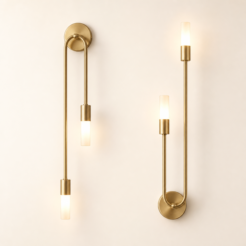 Two matching brass wall sconces with slim rods and glowing frosted cylindrical bulbs.