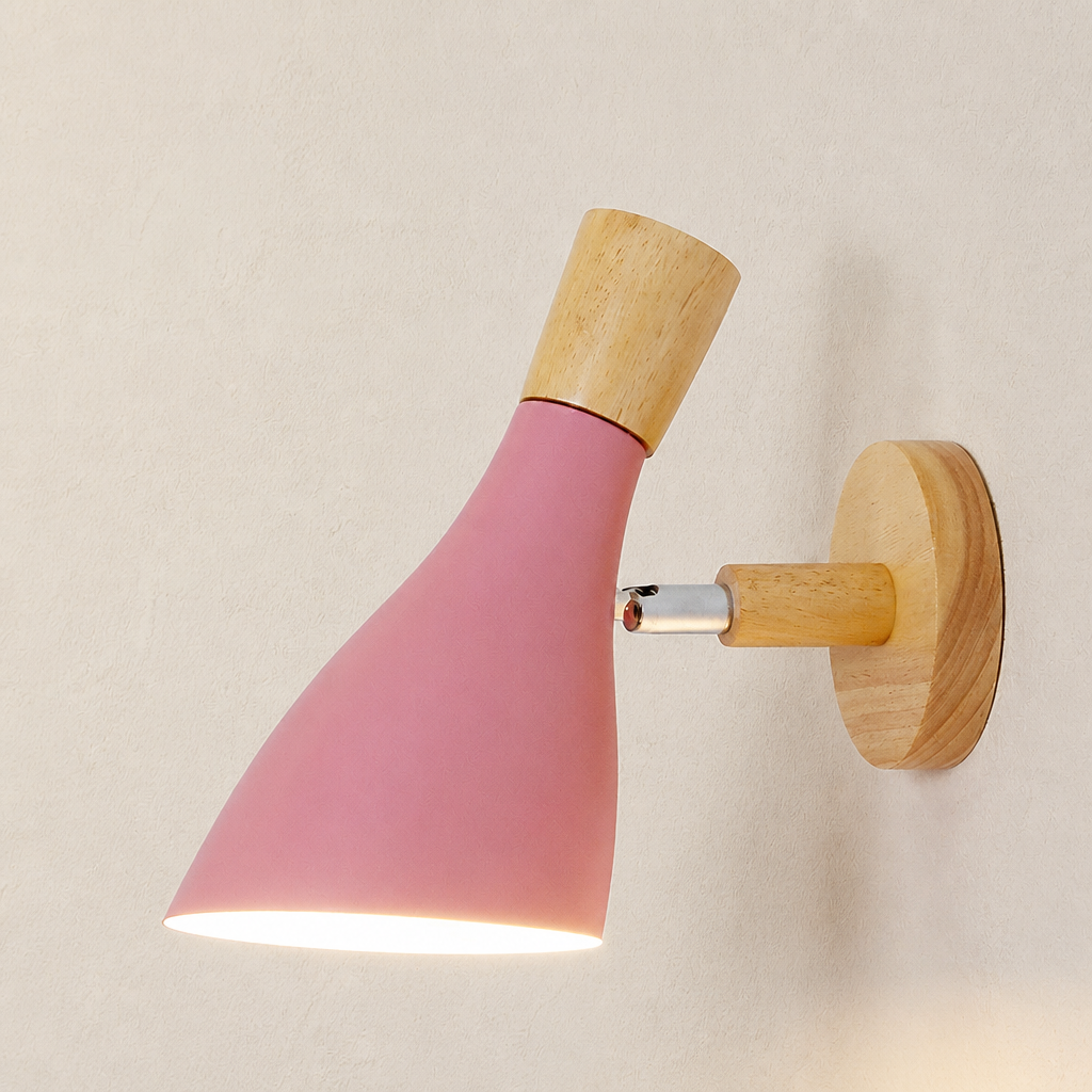 Pink cone wall sconce with wooden accents lit against a pale textured wall.
