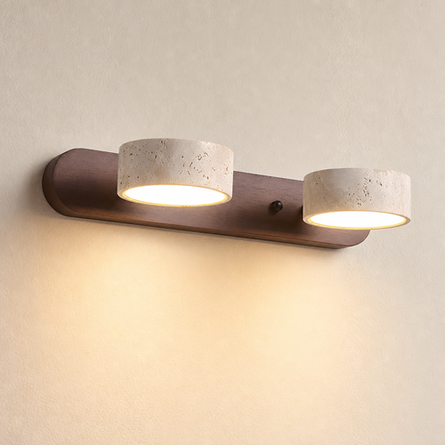 Two warm glowing cylinder lights on a wooden wall-mounted fixture.