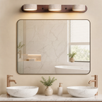 Three-light vanity fixture with stone shades above a bathroom mirror and marble sinks.
