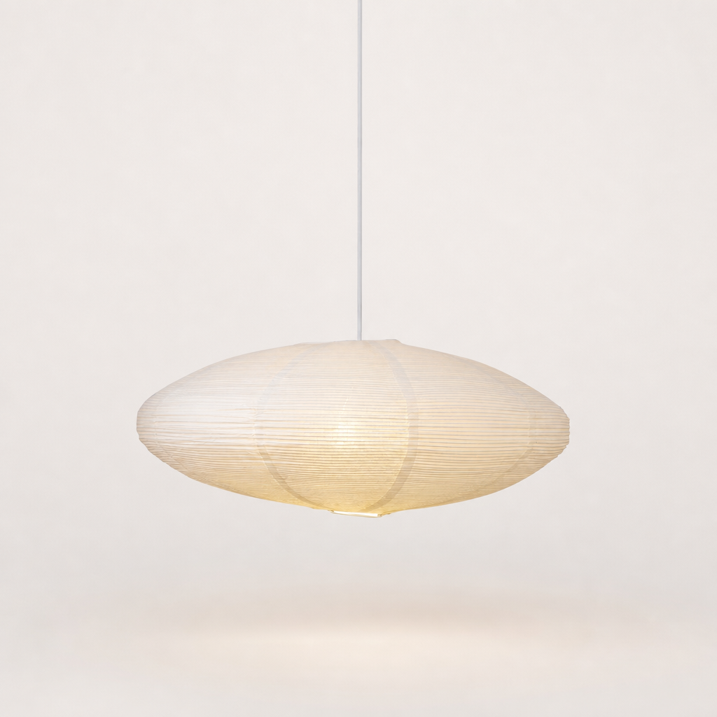 Warm oval ribbed paper pendant lamp with a white cord against a clean pale background.