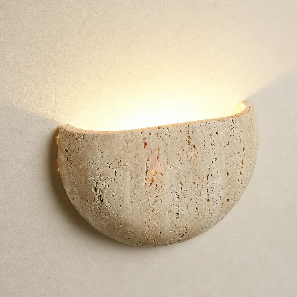 Beige textured half-bowl wall sconce casting a warm upward glow.